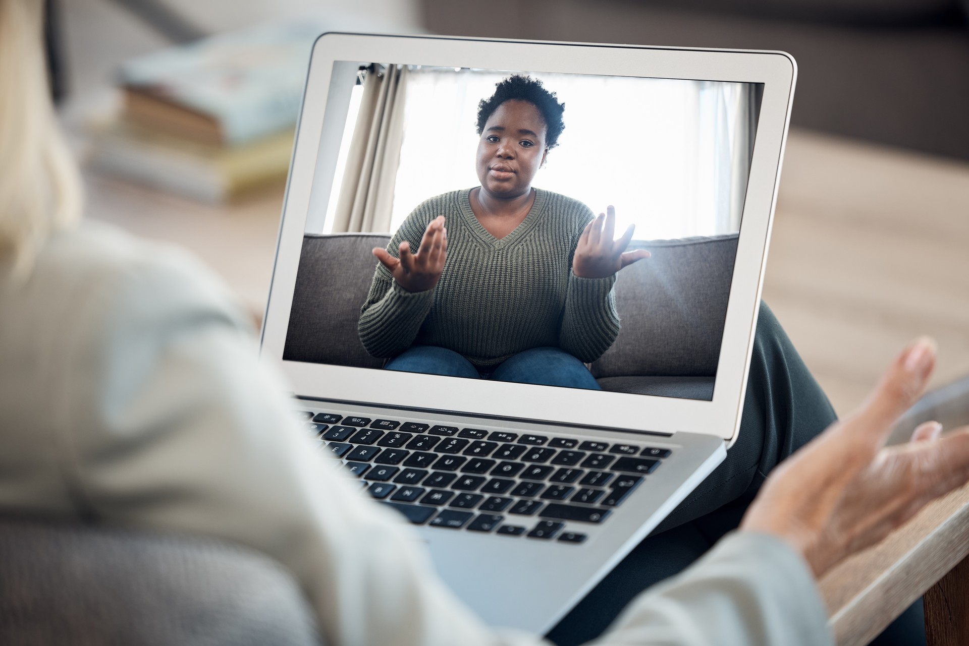 Woman, video call and therapy on laptop screen for support, advice or helping with mental health in online meeting. Virtual psychologist or therapist talk to client or african person on computer